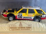 display case with a toy car in it and a plaque in the background