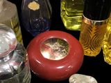 many different bottles of perfume on a black surface
