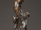 a bronze statue of a man on a rock with a dog