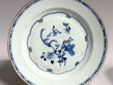 two blue and white plates with flowers on them