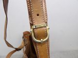 brown leather handbag with a strap and a metal buckle