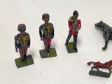 several figurines of toy soldiers and a horse on a white surface