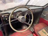 a steering wheel and dashboard of an old car