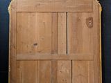 a large wooden door with a mirror on top of it