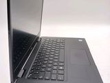 a laptop that is open on a white surface