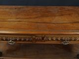 an old wooden table with a drawer underneath it on a black background