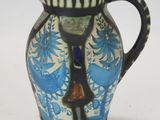 a blue and white vase with a bird on it