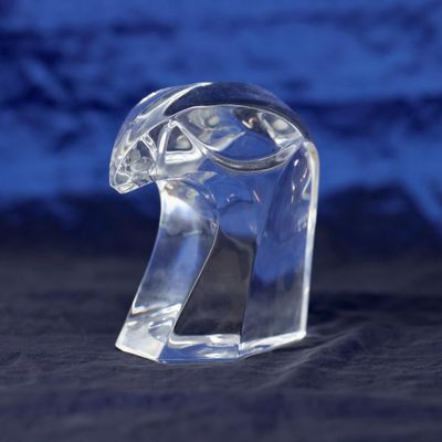 a clear glass animal figurine sitting on a black surface