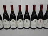 six bottles of wine are lined up on a table