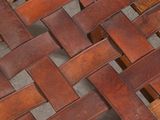 a close up view of a wooden table with a woven top