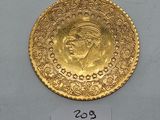 a close up of a gold coin on a white surface