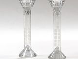 pair of clear glass candlesticks sitting on a white surface