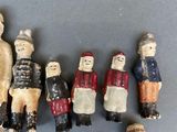 many figurines of people standing together on a table