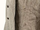 a close up of a man wearing a jacket and tie