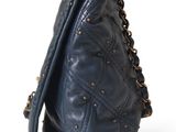 the back of a blue purse with studded straps on a white background