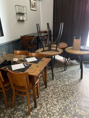 many tables and chairs in this small restaurant