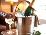 a bottle of champagne and a glass of wine on a table