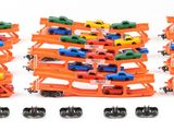 several toy cars are stacked on top of each other on a white surface