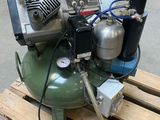 an air compressor sitting on a pallet in a warehouse