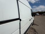 a white van that is parked in a parking lot