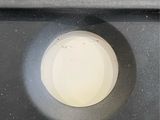 a close up of a toilet with a button on it