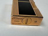 an image of a gold cigarette case sitting on top of a white table