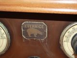 a close up of an old fashioned radio with a bear emblem on it