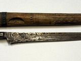 two knives that are sitting on a white surface