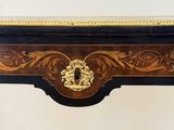 a black table with a gold decoration on top of it