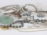 many different types of jewelry on a white surface