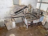 a dirty kitchen with a sink and a stove in it