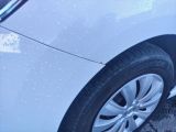 a close up of a car ' s tire with water droplets on it