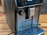 an espresso machine sitting on a wooden table in a room