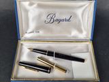 an image of a box with two pens and a notepad