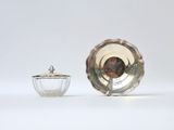 an image of a silver plate and a glass bowl on a white surface