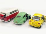 three toy cars that are next to each other on a white surface