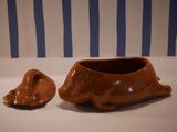 a brown bowl and a brown dog bowl on a table