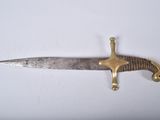 a very long knife that is laying on a table