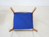 an image of a blue chair with a wooden frame on it