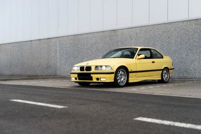 a yellow car parked on the side of the road