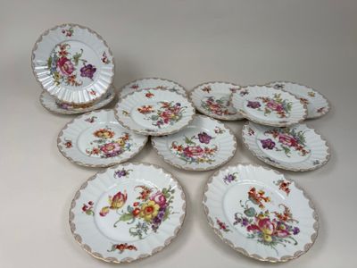 several plates with floral designs on them sitting on a table