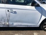a white car that has some dirt on the side of it