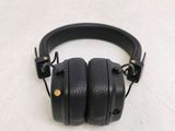 a pair of black headphones on a white surface