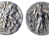 a silver coin with an image of a woman and a man on it