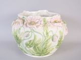a white vase with pink and green flowers painted on it