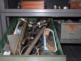 a green bin filled with assorted items in a room