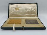 a case that has a gold and silver medal in it