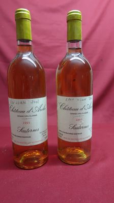 two bottles of wine sitting next to each other on a table