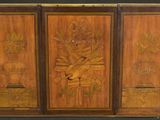 a wooden cabinet with carvings on the doors
