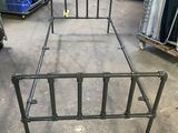 a metal bed frame that is in a warehouse